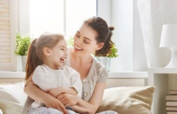 Happy loving family. Mother and her daughter child girl playing and hugging.